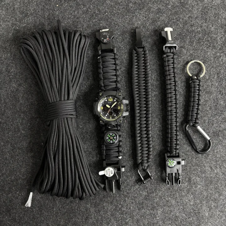 Cordage and outdoor utility accessories arranged on a dark surface